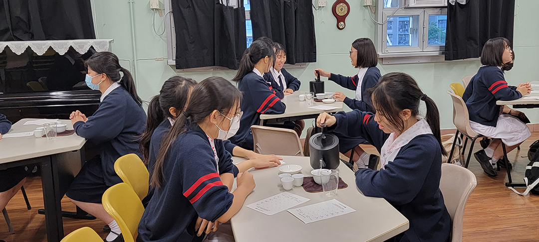 A group of students holding up their facesDescription automatically generated