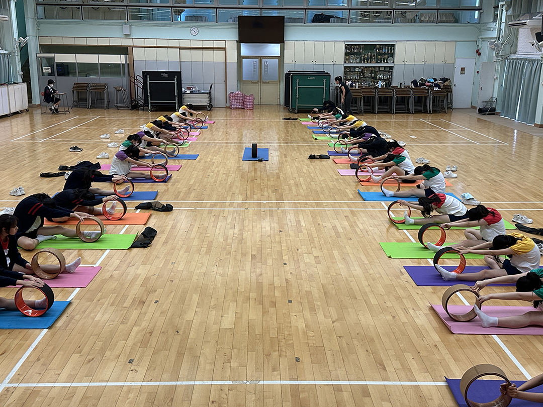 A group of people sitting on matsDescription automatically generated