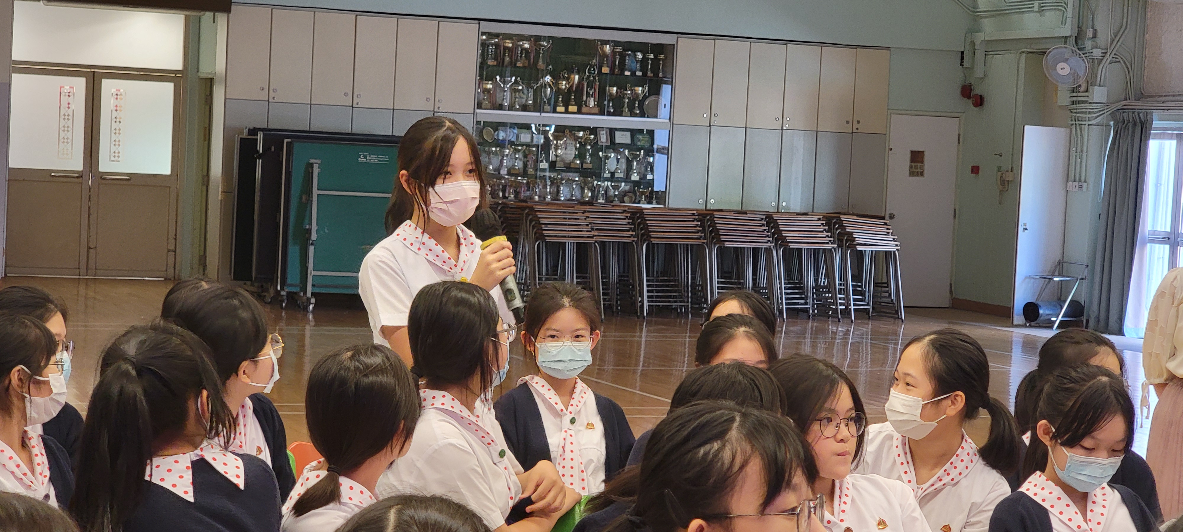 A group of people painting on a white tableDescription automatically generated