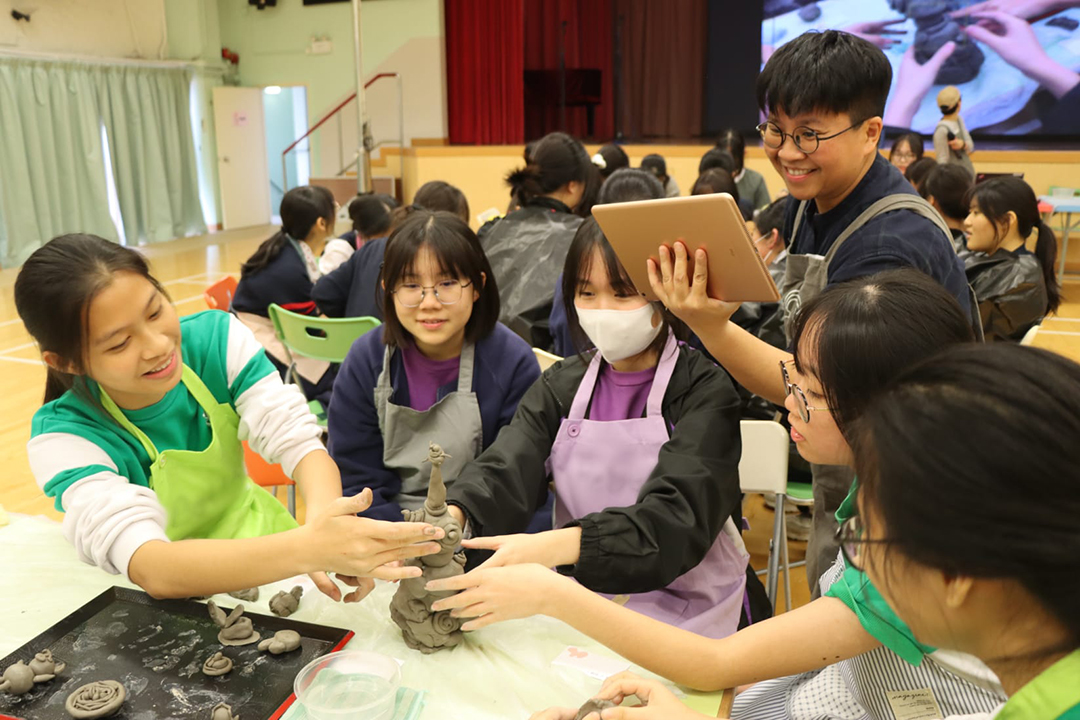 A group of people wearing face masks sitting at a tableDescription automatically generated