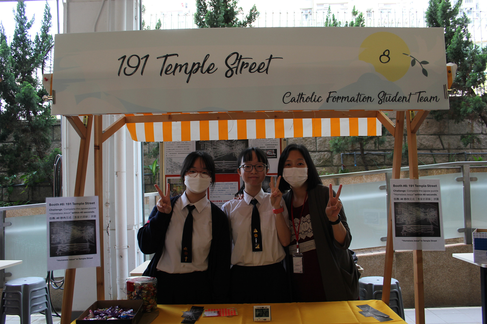 A group of girls wearing masks and standing in front of a statueDescription automatically generated