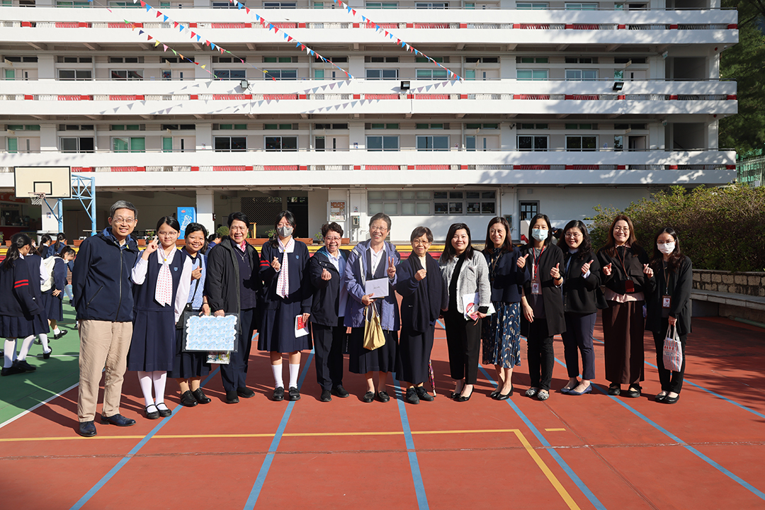A group of girls wearing masks and standing in front of a statueDescription automatically generated