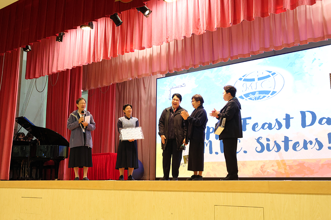 A group of girls wearing masks and standing in front of a statueDescription automatically generated