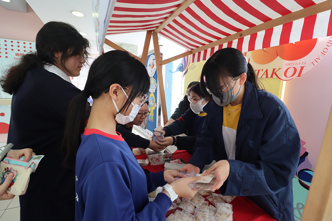 A group of girls wearing masks and standing in front of a statueDescription automatically generated